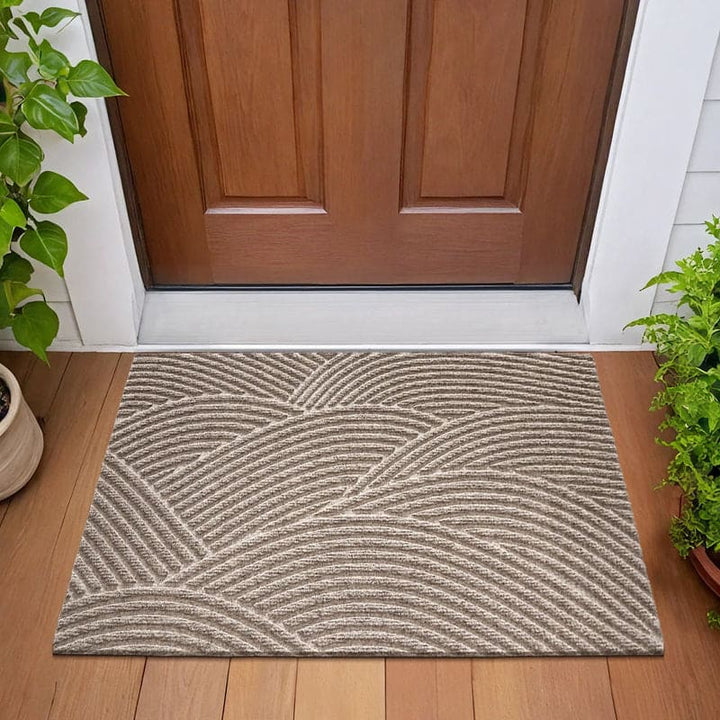 Beige 3D wave-patterned doormat placed at front entrance, complementing wooden flooring.