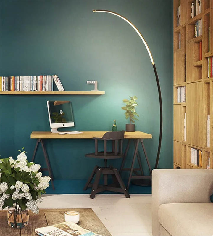 ARC Minimalist Floor Lamp beside tan leather sofa, casting soft light, perfect for reading nooks and Scandinavian lounges.