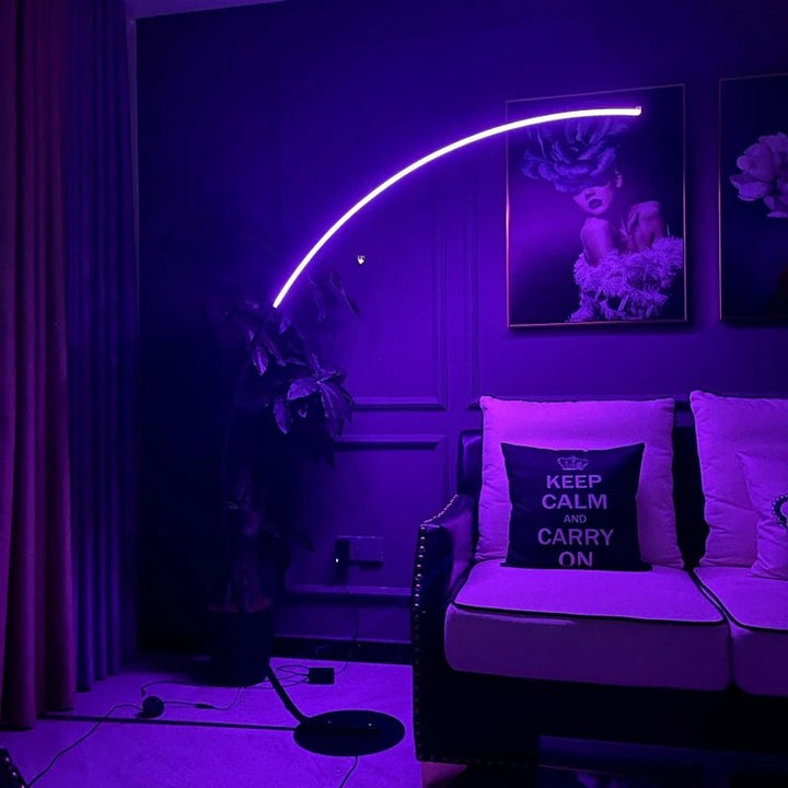 ARC RGB LED Floor Lamp glowing purple in moody living room setting, perfect for atmospheric lighting or creative spaces.