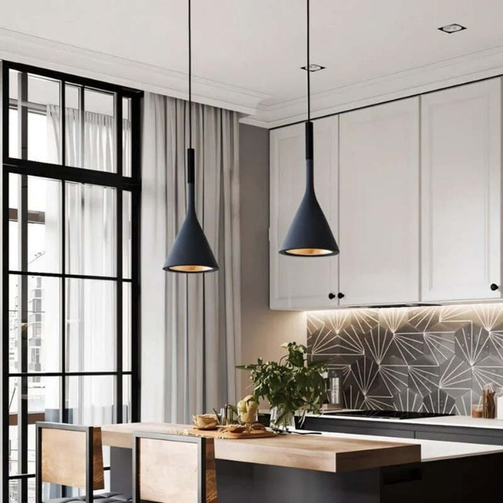 Modern kitchen with white cabinets, geometric backsplash, and pendant lights.