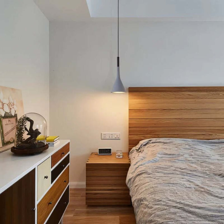 Modern bedroom with wooden headboard, nightstands, and dresser.
