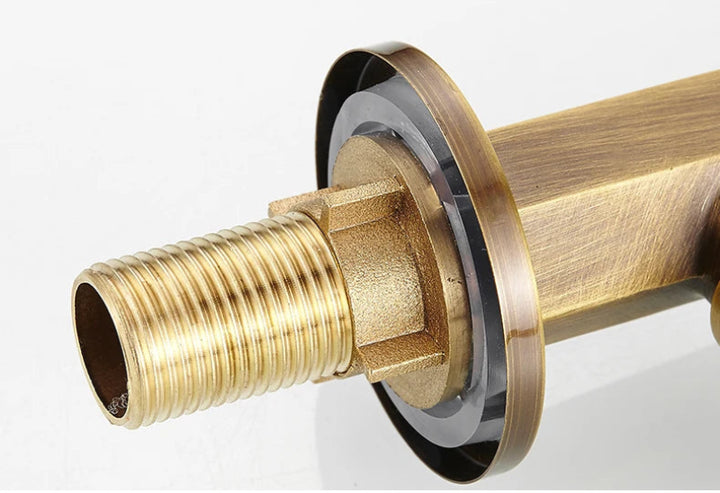 Close-up of a brass plumbing fitting on a white background