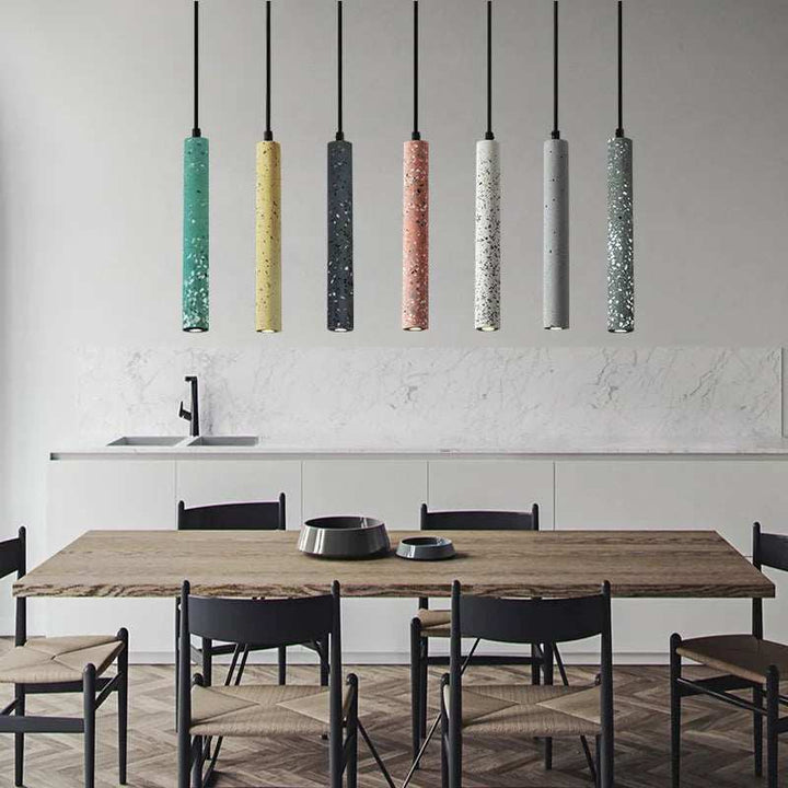 BETON industrial concrete pendant lights in assorted colours above dining table