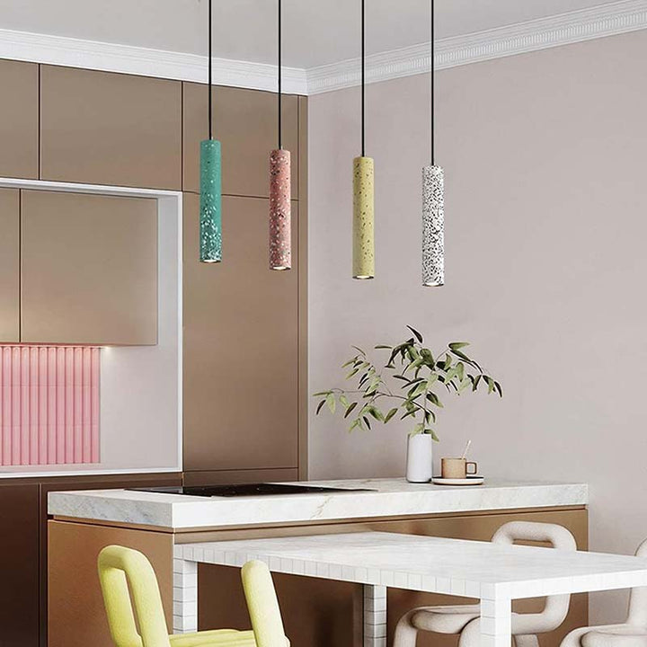Modern kitchen interior with pendant lights, a table, and chairs.