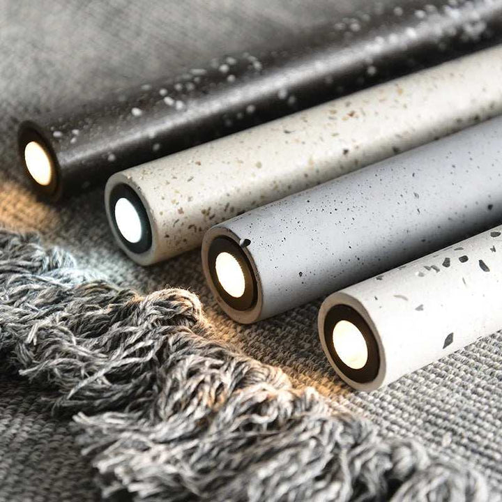 Detail view of BETON cement pendant lights in grey, white, and black terrazzo