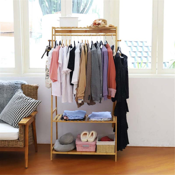 Compact bamboo wardrobe rack with rail, shelves, and clothing display, perfect for small bedrooms or entryways with Nordic decor themes.