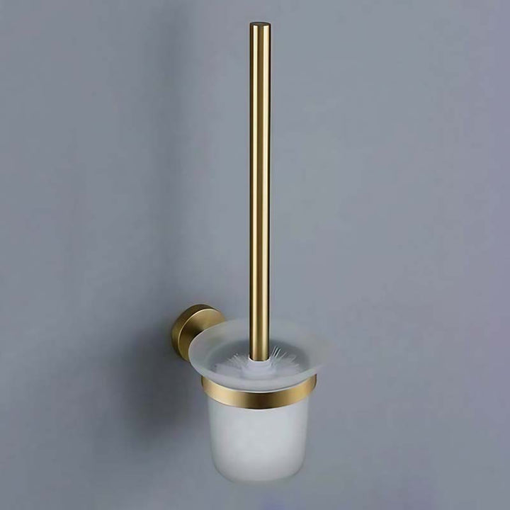 Gold toilet brush holder with white brush on a gray background