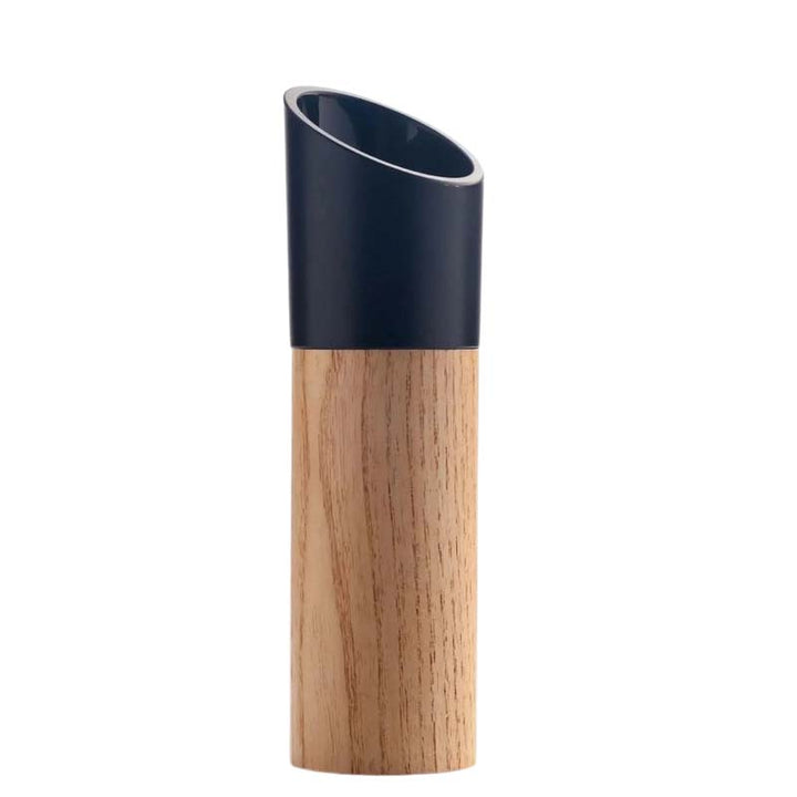 Beech wood kitchen grinder with the black grinding part on a white background