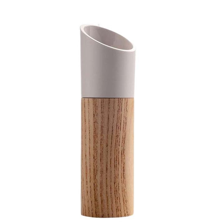 Beech wood kitchen grinder with the white grinding part on a white background