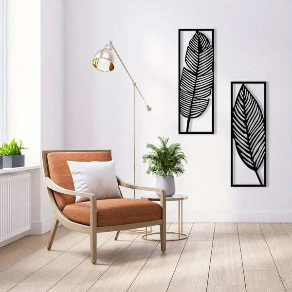 Modern living room with a brown armchair, leaf-shaped wall art, and a floor lamp.