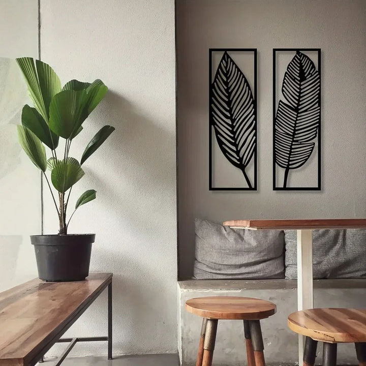 Modern interior with a plant, wooden table, stools, and wall art.