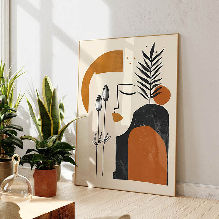 Modern abstract face print on canvas in orange, black and cream tones, framed artwork ideal for UK Scandi or boho home décor.