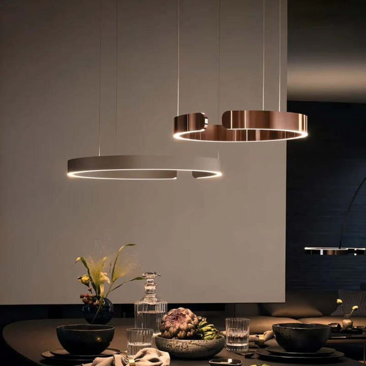 Dining room with gold and silver circular LED chandeliers – modern Nordic design