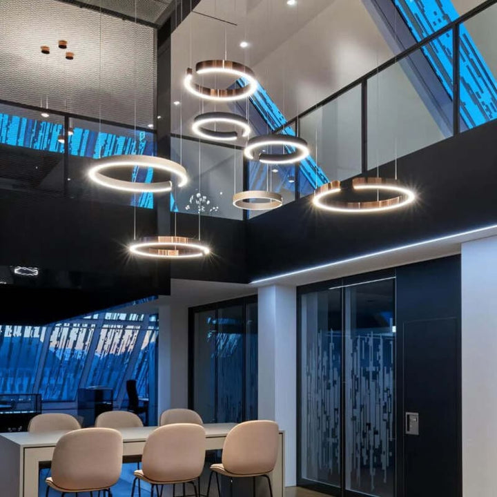 Stairwell with multiple circular LED chandeliers – gold and rose gold Nordic ceiling lights