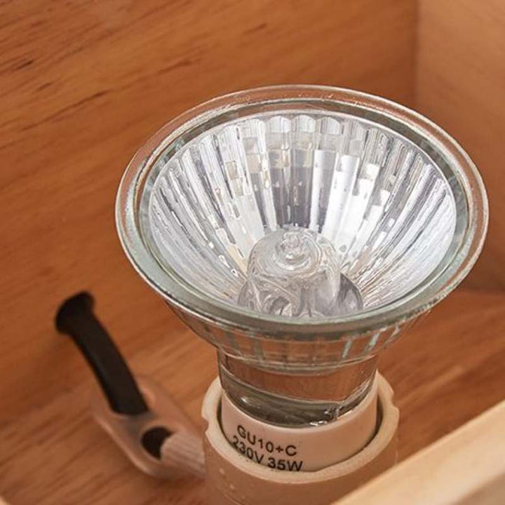 Close-up of GU10 halogen bulb inside wooden candle warmer lamp housing