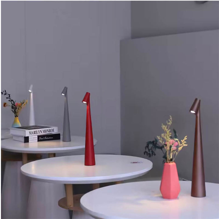 Colourful dimmable LED touch lamps on round tables, slim cordless lights for modern cafés or UK minimalist interiors.