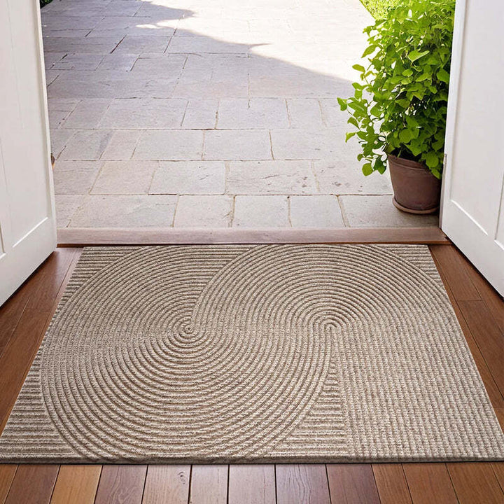 Beige 3D groove doormat at doorway entrance with natural sunlight and outdoor tiles in the background.