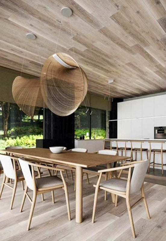 Set of two minimalist pendant lights hanging over tha dinning table on the outdoor patio, ideal for designer lounges 