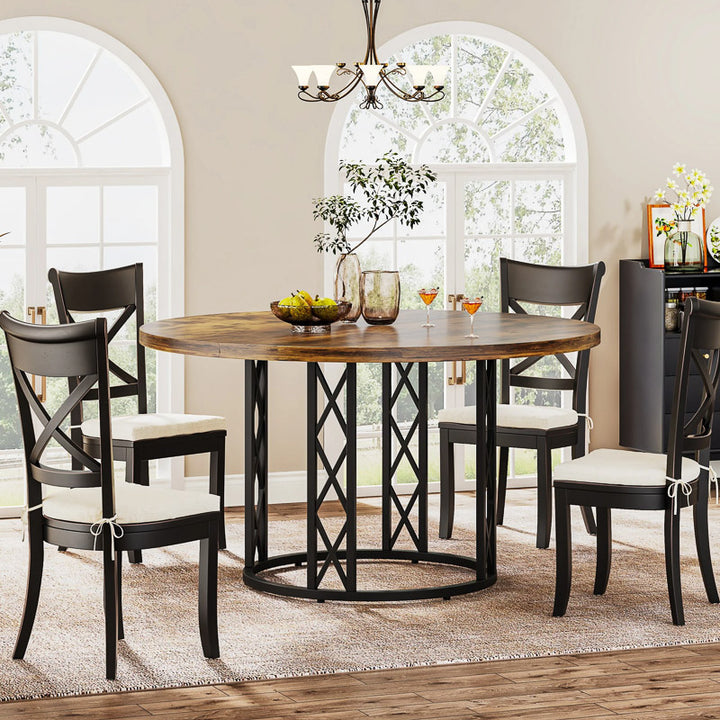 Dining room with a wooden table and black chairs in a well-lit room.