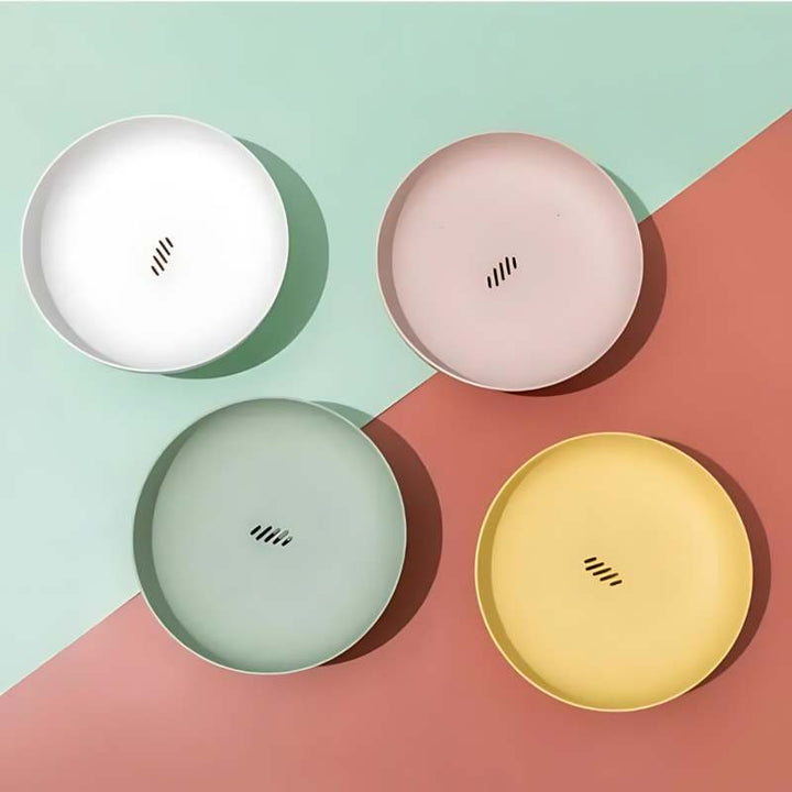 Elegant Scandinavian Fruit Bowl colourways—white, pink, mint, yellow—with drainage slots.