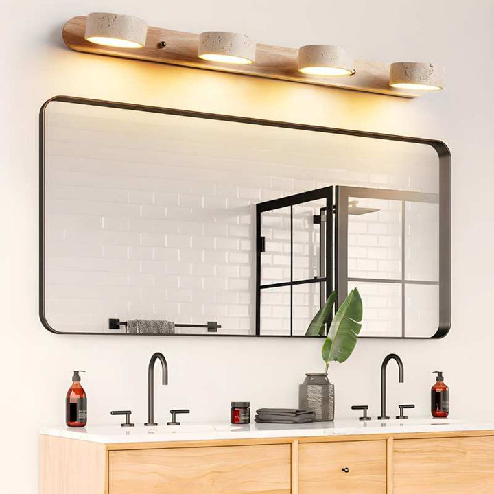 Bathroom vanity with large mirror, lights, and various items.