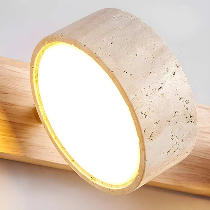 Concrete lamp with a warm glow on a wooden surface