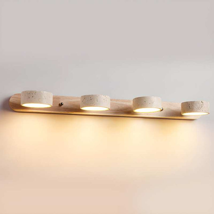 Wooden light fixture with four cylindrical bulbs on a plain wall.