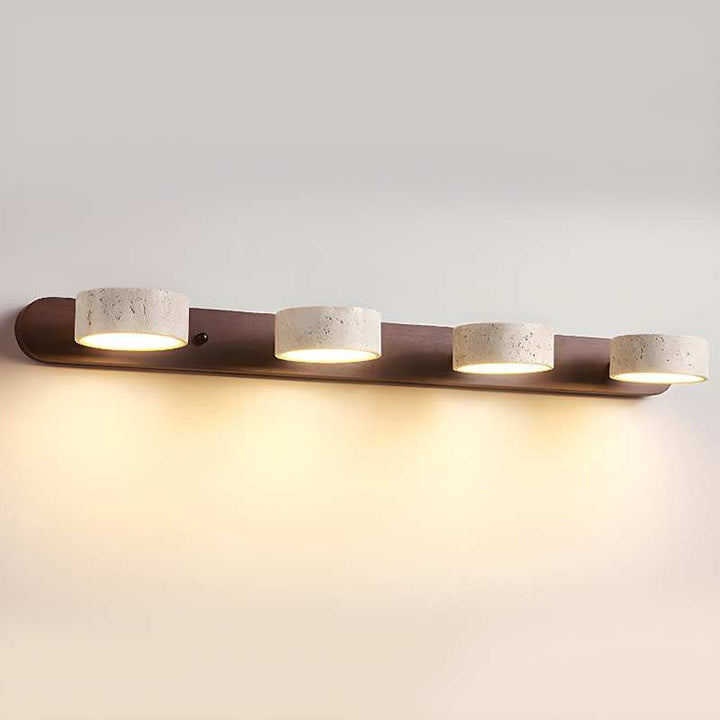 Modern wall-mounted light fixture with four ceramic bulbs on a neutral background