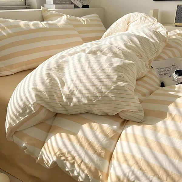 Beige and white striped bedding set with duvet cover and pillowcases for a modern Scandinavian bedroom