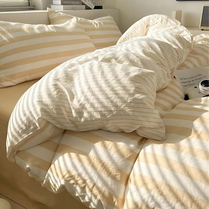 Beige and white striped bedding set with duvet cover and pillowcases for a modern Scandinavian bedroom
