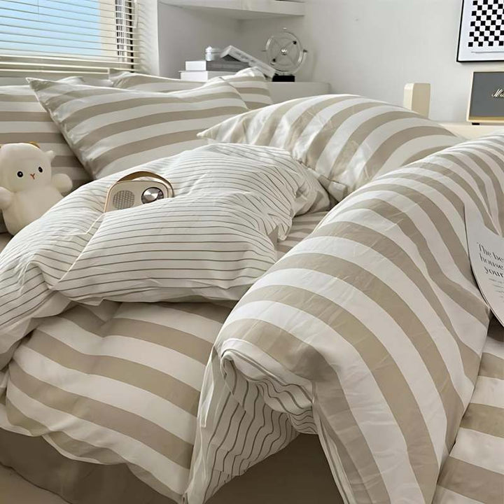 Taupe and white striped duvet cover set with matching pillowcases, minimalist bedroom bedding