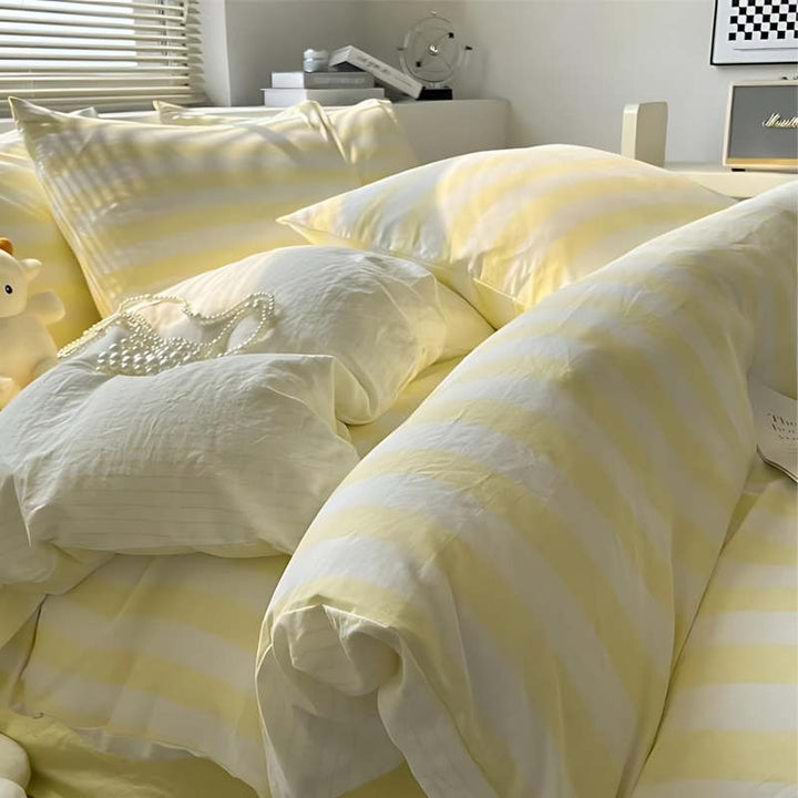 Soft yellow and white striped bedding set with duvet cover and pillowcases for airy bedrooms