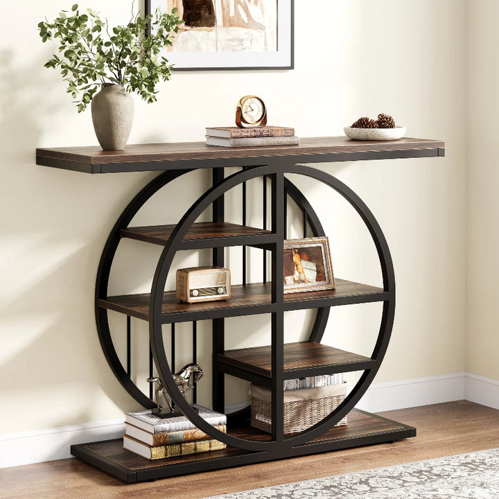 Decorative console table with circular metal frame and wooden shelves in a room.