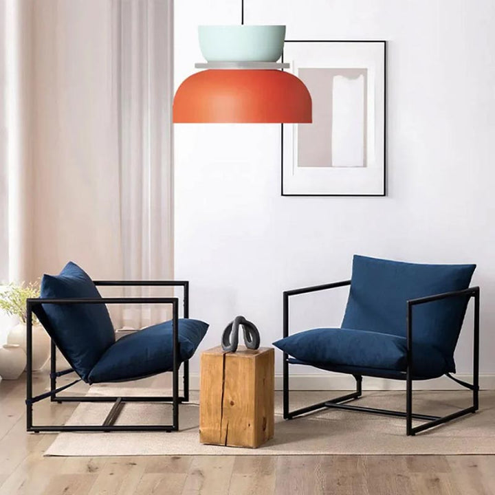 FARG Nordic Pendant Light – Orange LED macaron ceiling lamp above black and navy seating in a minimalist interior