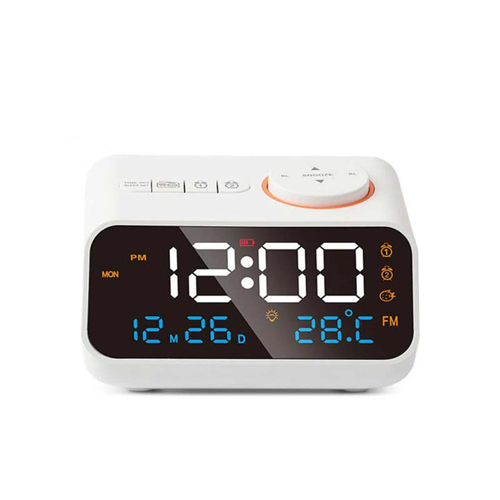 White FM Radio LED Alarm Clock on display screen showing time, date, and temperature, with large snooze button and modern digital interface.