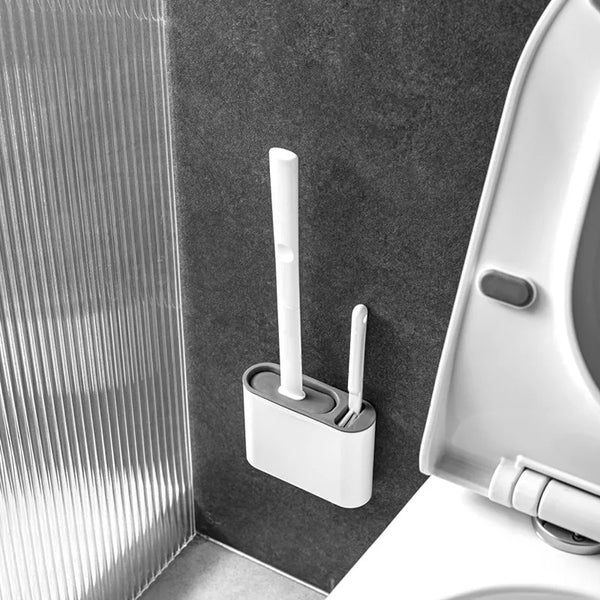 White toilet brush and holder next to a toilet in a bathroom setting.