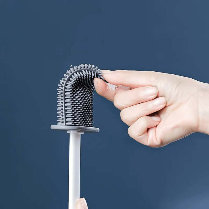 Hand interacting with a unique hairbrush against a dark blue background