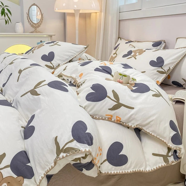 Soft cotton bedding set with dark purple tulip floral pattern and neutral tones, designed for a cozy Scandinavian-inspired bedroom ambiance.