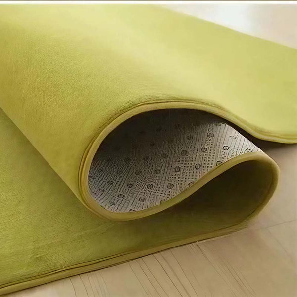 Green rug on a light wooden floor