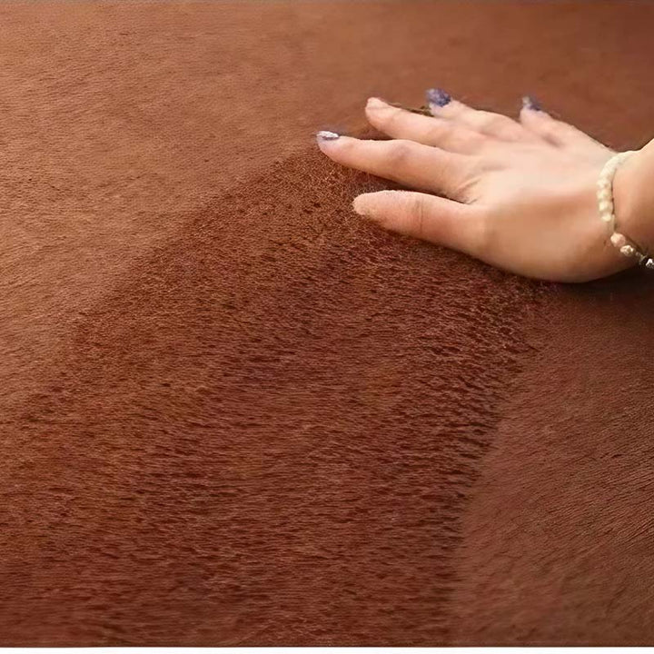Hand touching a brown textured fabric surface
