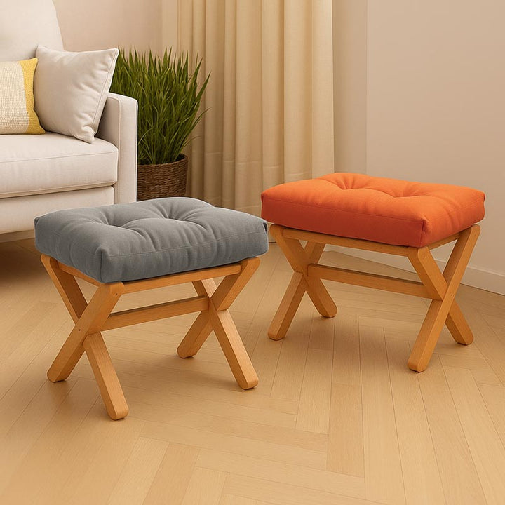 Modern foldable footstool with orange and grey padded cushions, beech wood X-frame design, perfect for Nordic living rooms or small spaces.