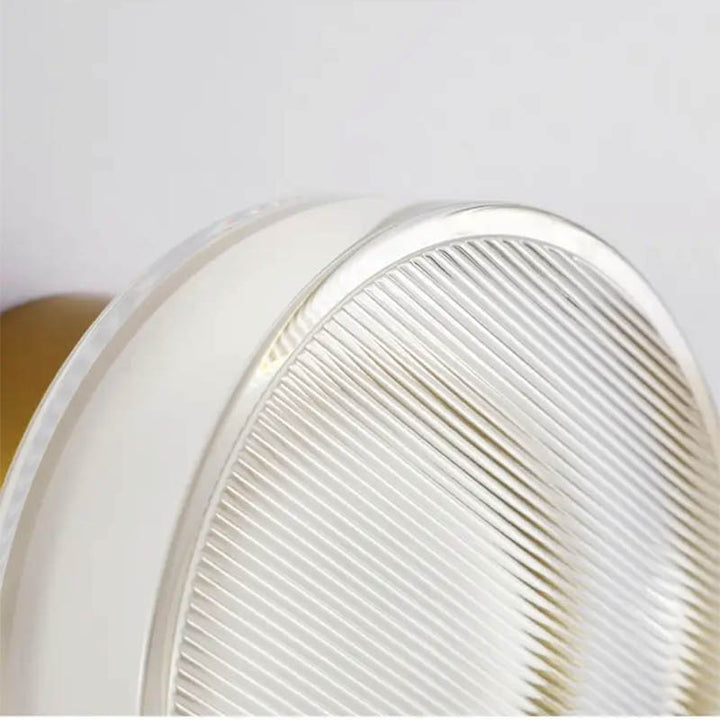 Textured stained glass diffuser on ILD wall lamp, showing prismatic lens detail and quality craftsmanship.