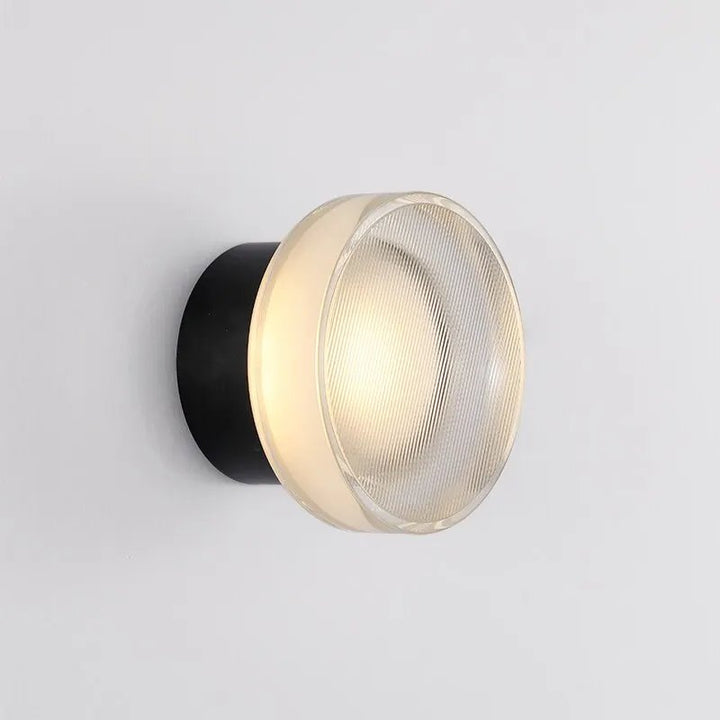 ILD glass wall sconce with black aluminium base and frosted lens, minimalist accent lighting for modern uk homes.