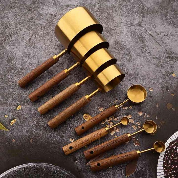 Gold & wood measuring spoon set, minimalist kitchen essential for precise baking.