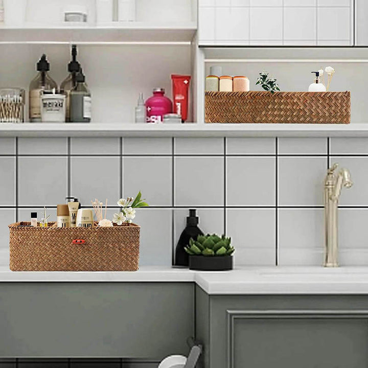 Modern tiled bathroom with two handwoven wicker organisers holding cosmetics, towels and decor for elegant countertop storage.