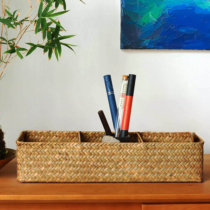 Rectangular woven basket styled on wooden surface with art supplies, divided compartments ideal for desktop or creative use.