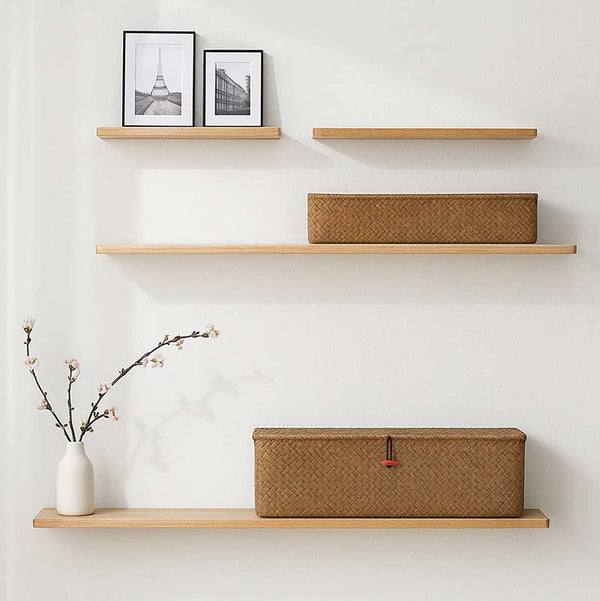 Wall-mounted minimalist shelving with natural wicker storage baskets, ideal for Scandinavian décor and modern home styling.