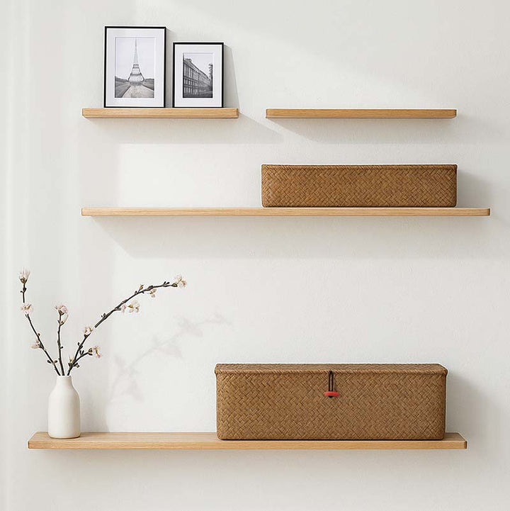 Wall-mounted minimalist shelving with natural wicker storage baskets, ideal for Scandinavian décor and modern home styling.
