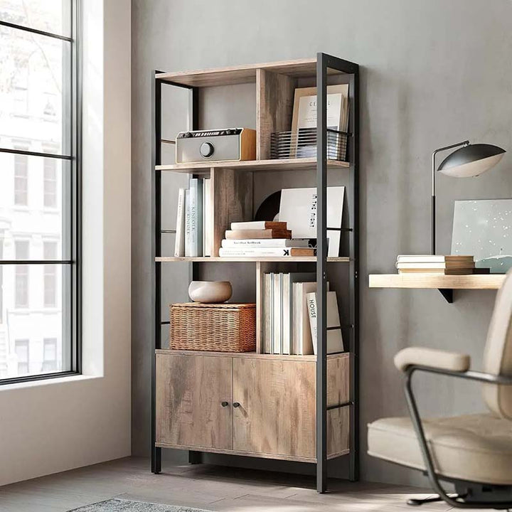 Bookshelf with books and decor items in a room with a window and chair.