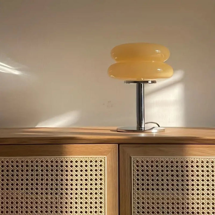Soft yellow Murano-style glass table lamp on chrome stand, perfect for Scandi-inspired living room decor.